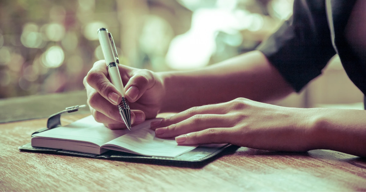 someone writing in a journal