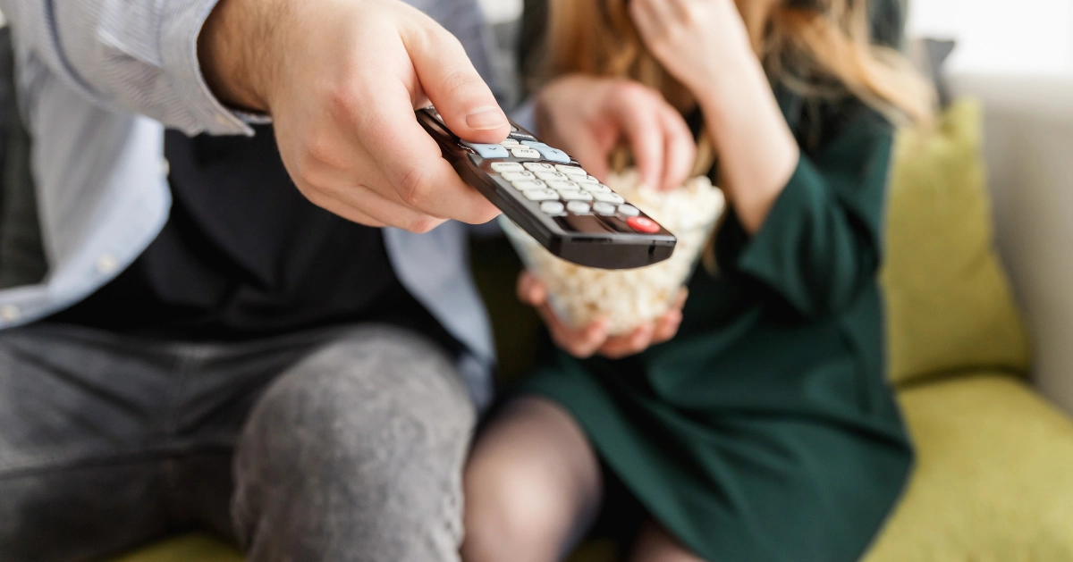 A Guy holding a TV remote