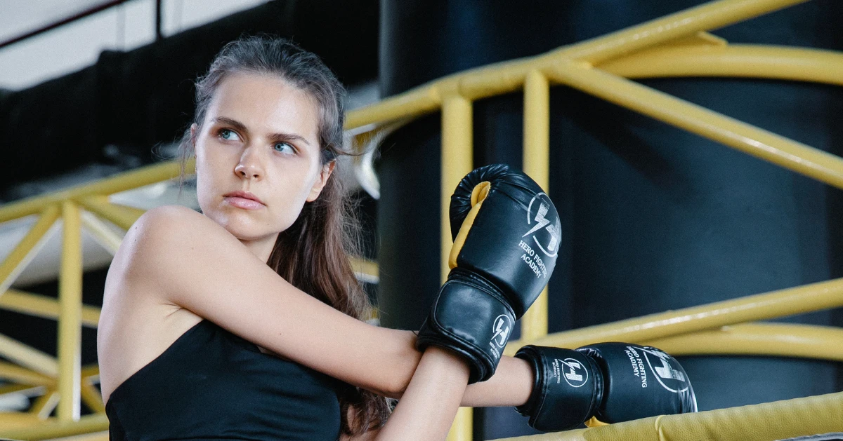 Female boxer showing strength while warming up.