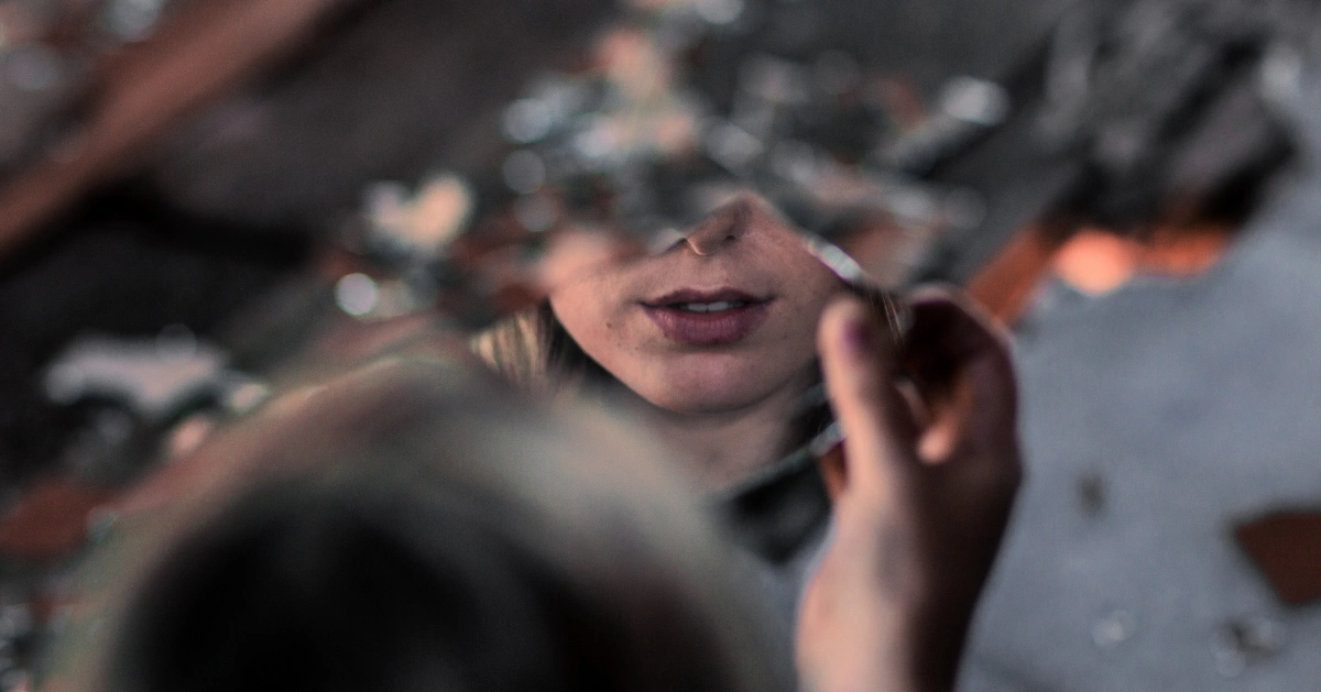 a girl's reflection in the mirror