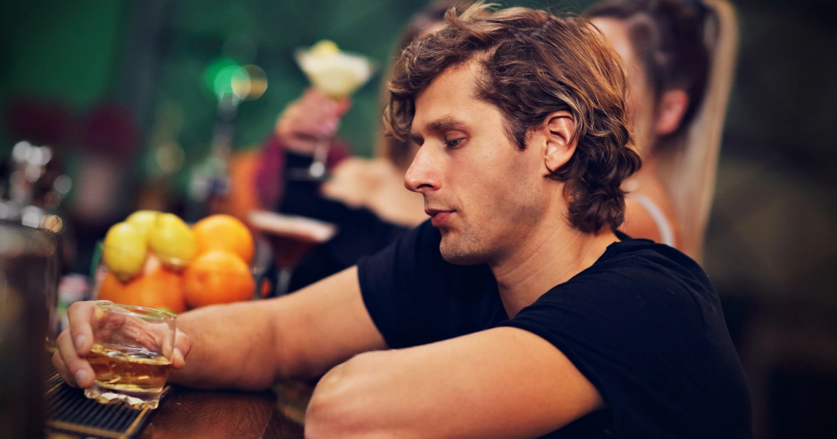 a guy at the bar drinking