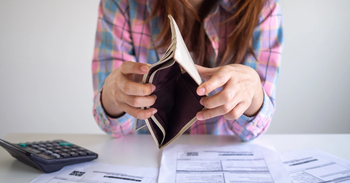 a girl showing she has no money in her wallet