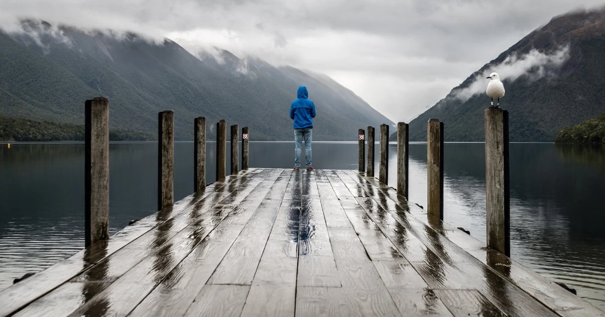 a person on the end of a pier alone