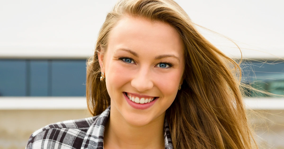 a young teen girl smiling at the camera