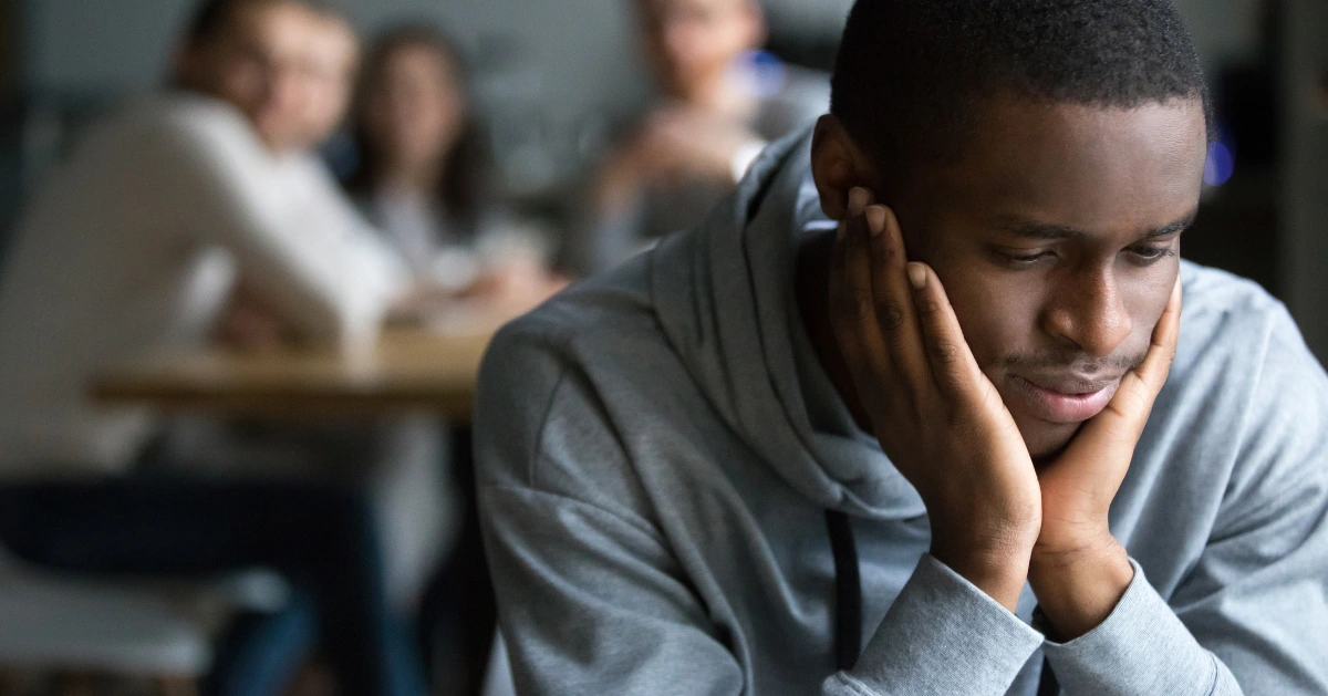 a teen sitting in class depressed