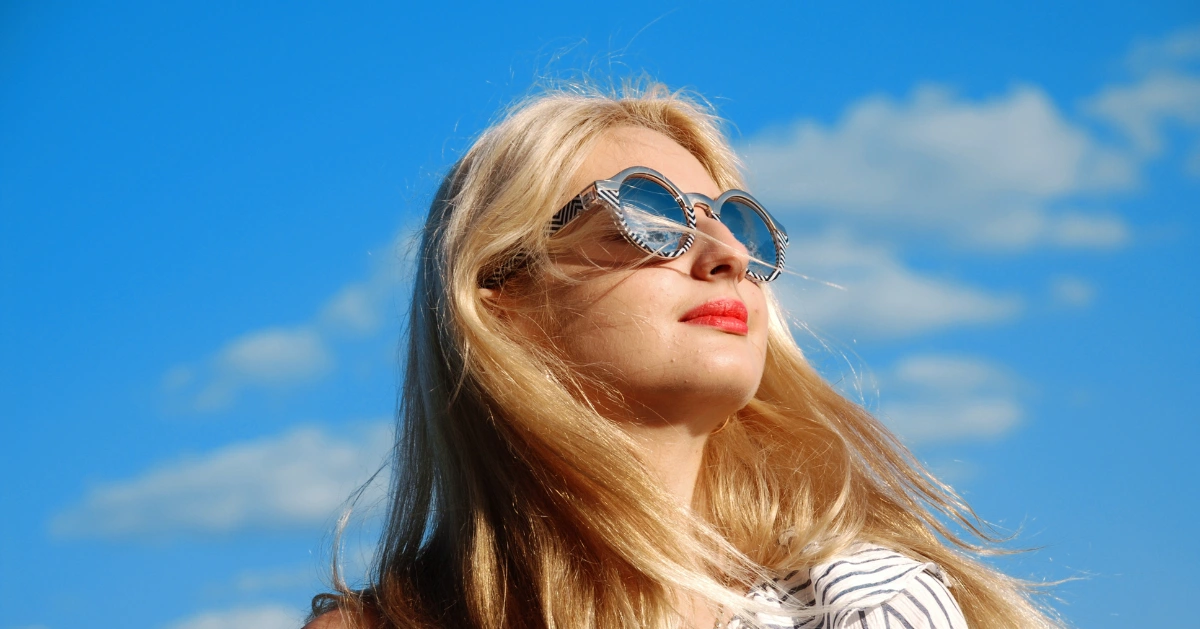 a girl looking up towards the sun