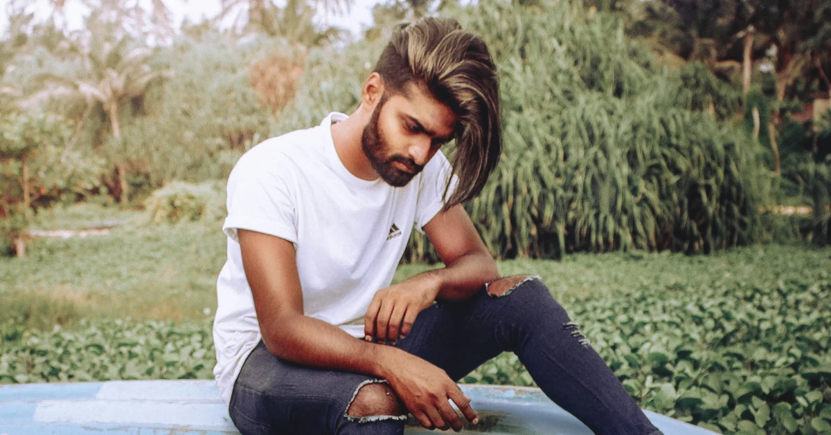 A guy sitting looking depressed