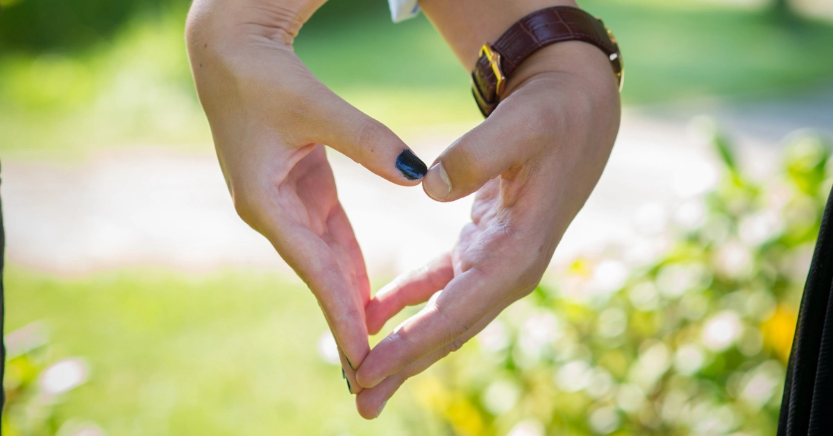 Girl and Guy hand coming together to make a heart