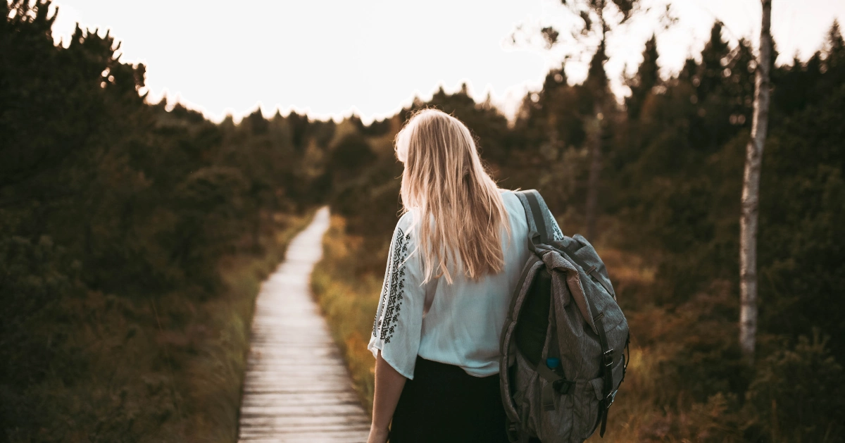 TheHopeLine girl outside walking down a path with a backpack