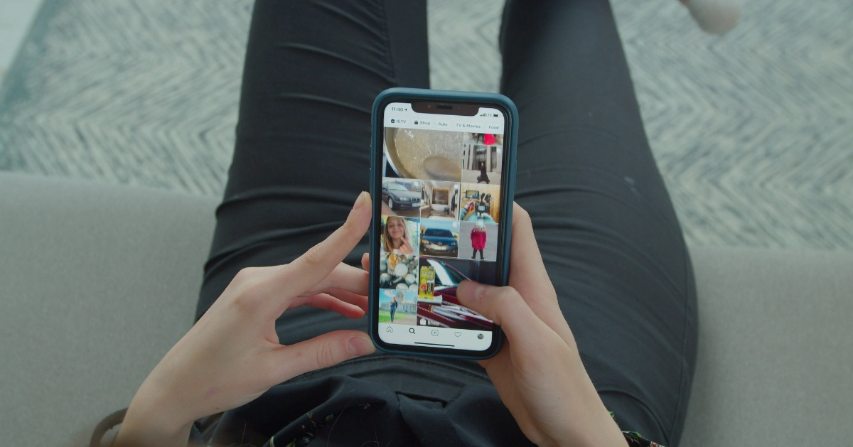 Woman browsing fashion trends on smartphone.